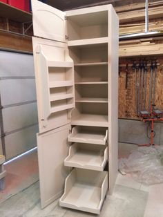 an empty storage cabinet in a garage with no doors on the front and back sides