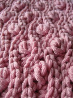 the texture of a pink knitted blanket