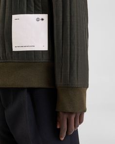 the back of a man's jacket with a label on it that says,