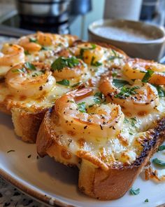 bread with shrimp and cheese on it sitting on a plate