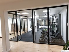 an empty gym room with mirrors and exercise equipment in it's centerpieces