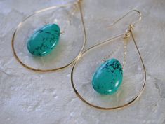 Large handcrafted gold hoop earrings fashioned into a teardrop shape and accented with a bold Turquoise briolette in the center. These lovely statement earrings are handcrafted from 14k gold filled metal, shaped and hammered for shine and texture. The teardrop shape highlights the bold Turquoise gemstone that hangs in the center for a one of a kind statement look. Earring Length 3.5 inches Earring Width at the base 2 inches Threaded Turquoise Necklace: http://www.etsy.com/listing/637197368 LINKS Gold Hoop Earrings Style, Big Gold Hoop Earrings, Turquoise Earrings Gold, Large Gold Earrings, Turquoise Hoop Earrings, Geode Earrings, Mixed Metal Jewelry, Earrings Hoop, Upcycled Jewelry