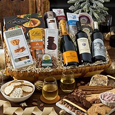 an assortment of wine, cheese and crackers in a basket