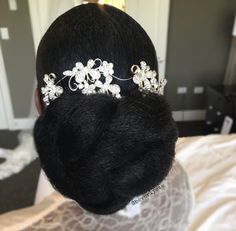 the back of a woman's head wearing a tiara