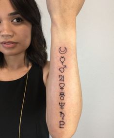 a woman is holding up her arm with the word love written in two different languages