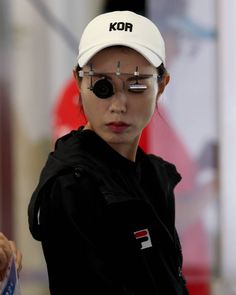 a woman with eye glasses and a hat on