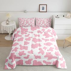 a bed with pink and white designs on it