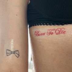 two women with tattoos that say born to die and bow ties on their thighs,