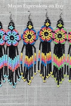 four pairs of colorful beaded earrings hanging from hooks on a gray background with text overlay