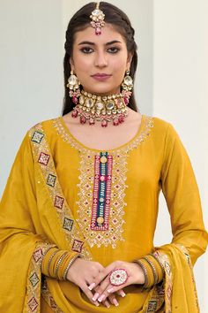 This Mustard color Party Wear Palazzo Salwar Suit flaunts sophistication with zari, resham, badla, and sequence work along the kameez. Accented by a baluming chinnon silk embroidered palazzo bottom, santoon lining, and sequence embroidered baluming chinon silk dupatta, this ensemble is perfect for weddings and other special events. Final sale Kameez baluming chinon silk with heavy embroidery & sequin work Sharara baluming chinon silk with heavy embroidery front and back Dupatta baluming chinon s Festive Slub Silk Churidar With Resham Embroidery, Mirror Work Slub Silk Palazzo Set For Festivals, Slub Silk Palazzo Set With Mirror Work For Festivals, Gold Chanderi Palazzo Set With Pallu, Bollywood Style Slub Silk Palazzo Set With Mirror Work, Festive Gota Work Dola Silk Kurta, Wedding Sets With Mirror Work In Slub Silk, Gold Slub Silk Salwar Kameez With Resham Embroidery, Gold Salwar Kameez With Resham Embroidery In Slub Silk