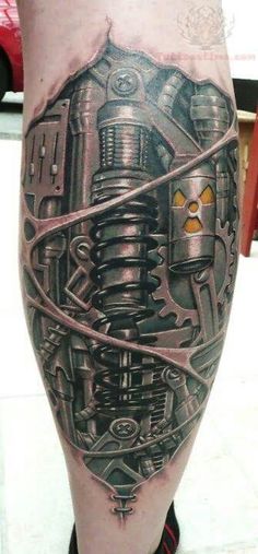 a man's leg with a tattoo on it that has an image of a machine