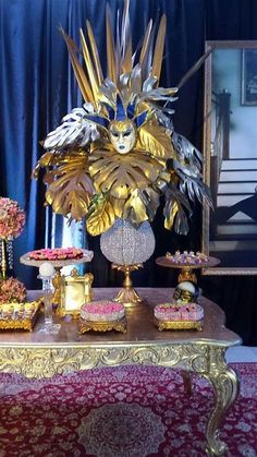 an elaborately decorated table with cakes and cupcakes