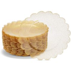 a bowl with some food in it on a white tablecloth and paper doily