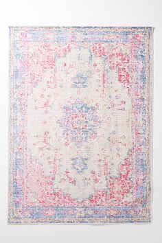 an area rug with red, blue and white colors on the bottom half of it