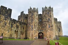 the entrance to an old castle on a cloudy day