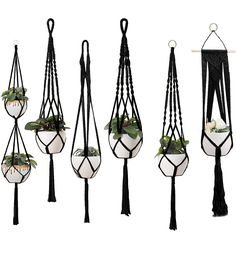 four hanging planters with plants and tassels attached to the sides, all in different shapes and sizes