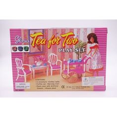 a box with a doll in it that is next to a toy table and chairs