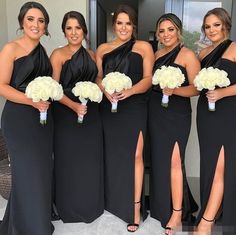 the bridesmaids are all wearing black dresses with white flowers in their bouquets