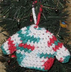 a knitted ornament hanging from a christmas tree