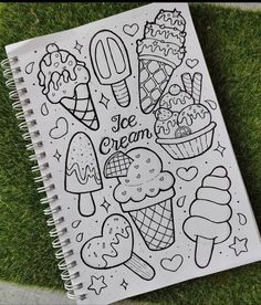 a coloring book with ice cream on it sitting in the grass next to a sidewalk