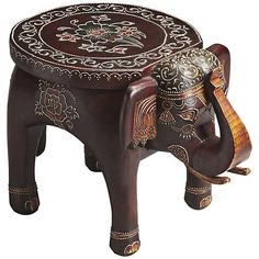 an elephant stool is decorated with intricate designs