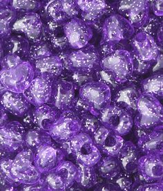 purple beads with white dots are shown in this close up photo, as well as the background