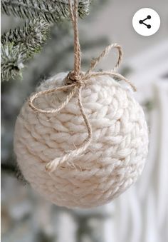 an ornament hanging from a christmas tree with twine and rope on it