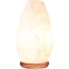 a white himalayan salt lamp on a wooden base