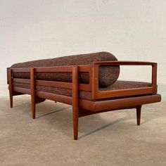 a brown couch sitting on top of a wooden frame