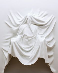 a white sculpture is shown in the middle of a room