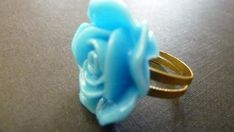 A lovely vintage style adjustable flower ring with a brass base on which sits a beautiful sky blue rose flower. The flower measures about 20mm.I will ship this out lovingly wrapped in tissue and a beautiful organza bag for easy gift giving.For more adjustable rings, please go to http://www.etsy.com/shop/Dewdropsdreams?section_id=10878805For more vintage style, bridal and fun jewelry, please visit my shop at www.dewdropsdreams.etsy.com.Thank you for visiting my shop. Elegant Blue Adjustable Flower Ring, Elegant Adjustable Blue Flower Ring, Adjustable Blue Flower Ring, Adjustable Blue Flower Ring For Gifting, Adjustable Blue Flower Ring Gift, Blue Rose Flower, Light Blue Roses, Buy Jewellery Online, Blue Ring