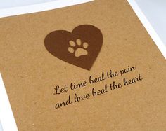 a brown card with a heart and paw prints on it, says let time heal the pain and love heal the heart