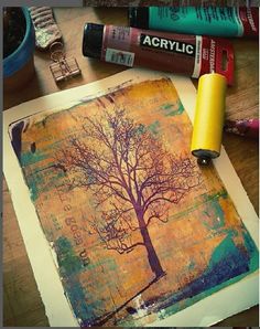 an altered photograph of a tree on a piece of paper with crayons next to it