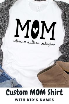 Super cute, unisex shirt with the word, "Mom" and kid's names below with adorable hearts. Great t-shirt for a Mom birthday gift, Mother's Day gift, baby shower gift, or a New Mom gift. #shirtformom #personalizedmomshirt #personalizedmomgift #momshirtwithnames #momshirtwithkidsnames #custommomshirt #babyshowergiftideas #newmomgiftideas #bestmomgift #mombirthdayshirt Cotton T-shirt With Name Print For Family Events, Cute Family T-shirt With Letter Print, Cute Letter Print Tops For Family Events, Family Matching Custom Name T-shirt As A Gift, Family Matching T-shirt With Custom Name As Gift, Mother's Day Cotton T-shirt For Family Events, Custom Name T-shirt For Family Matching Gift, Custom Name Family Matching T-shirt, Mother's Day Gift Tops With Letter Print