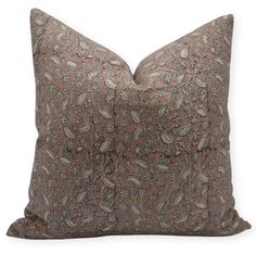 a brown pillow with an intricate design on it's back and the front is made out of fabric