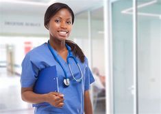 a woman in scrubs is smiling and holding a blue folder while wearing a stethoscope