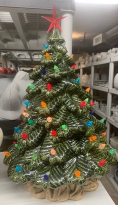 a green christmas tree sitting on top of a counter