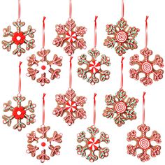 christmas ornaments with candy canes hanging from red string on white background, including snowflakes and candy canes