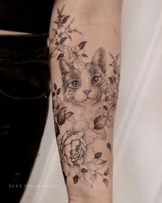 a cat with flowers on it's arm