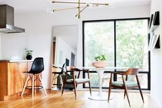 a dining room with wooden floors and white walls