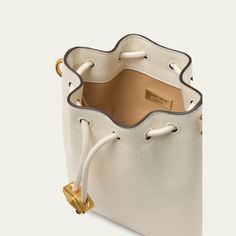 Jimmy Choo "Bon Bon" north-south bucket bag in shiny calfskin leather and brass Detachable crossbody strap Drawstring closure  Approx. 6"H x 4"W x 6"D Made in Italy Calf Leather Bucket Shoulder Bag With Gold-tone Hardware, Calf Leather Bucket Bag For Travel, Luxury Leather Bucket Bag With Gold-tone Hardware, Luxury Calf Leather Bucket Bag With Gold-tone Hardware, Calf Leather Bucket Bag For Evening, Evening Calf Leather Bucket Bag, Formal Calf Leather Bucket Bag, Calf Leather Bucket Bag With Dust Bag, Luxury Formal Bucket Bag