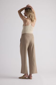 The Kelly Cami is a versatile everyday essential, perfect for layering as a top or wearing alone as a chic slip dress. Crafted from ribbed material, it offers comfortable stretch for a flattering fit. Stretch Tank Top For Spring Loungewear, Stretch Spring Tank Top For Loungewear, Chic Seamless Spring Bottoms, Chic Beige Ribbed Tank Top, Chic Seamless Loungewear Bottoms, Chic Seamless Tank Top For Loungewear, Ribbed Spring Tank Top With Minimal Stretch, Ribbed Tank Top With Minimal Stretch For Spring, Chic Cotton Bottoms For Layering