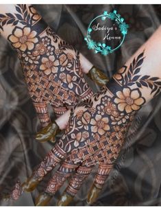 two hands with henna designs on them