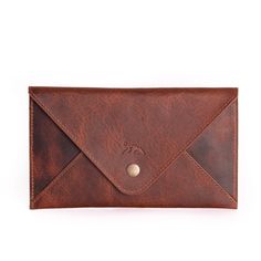 a brown leather wallet with a button on the front and an envelope in the back