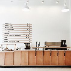 an empty room with white walls and wooden furniture