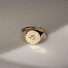 Our modern take on the classic heirloom signet ring. North Star symbolizes inspiration and hope. It guide you through the dark night, navigate towards your destination. Round face signet ring with a white diamond set into traditional starburst engraving. Made to order: Please allow 4 weeks production time as each piece is created just for you. Made with recycled 14K Yellow Gold Round face diameter = 10mm 2.5mm White Diamond total Carat weight 0.03 ct. Handmade in NYC Classic 14k Gold Star Shaped Signet Ring, Classic Star-shaped Signet Ring With Polished Finish, Classic Star Shaped Signet Ring With Polished Finish, Classic Polished Star Shaped Signet Ring, Elegant Star-shaped Diamond Signet Ring, Elegant Diamond Star-shaped Signet Ring, Elegant 14k Gold Star-shaped Signet Ring, Elegant Diamond Star Signet Ring, Timeless Signet Ring With Single Diamond