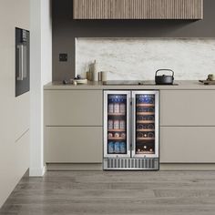 an open refrigerator in the middle of a kitchen with stainless steel cabinets and counter tops