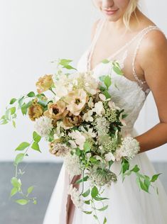 a woman holding a bouquet of flowers in her hands