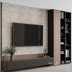 a large flat screen tv mounted to the side of a wall next to a book shelf