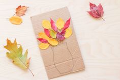 some leaves are laying on top of a piece of paper with a string attached to it